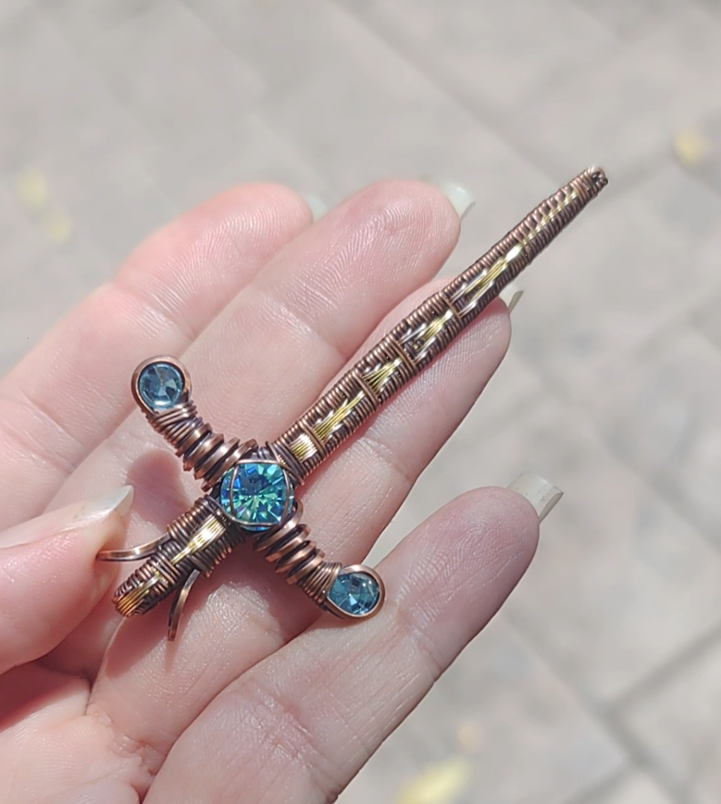 Gold Sword ⚔️ with three blue crystals