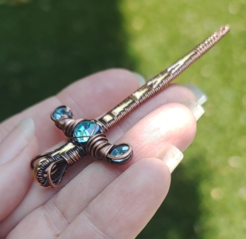 Gold Sword ⚔️ with three blue crystals