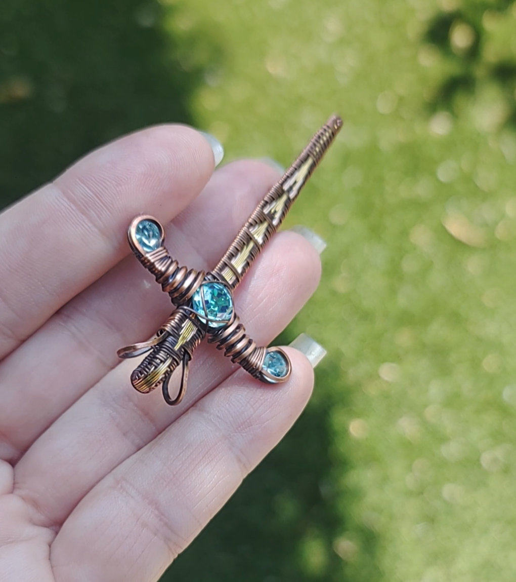 Gold Sword ⚔️ with three blue crystals