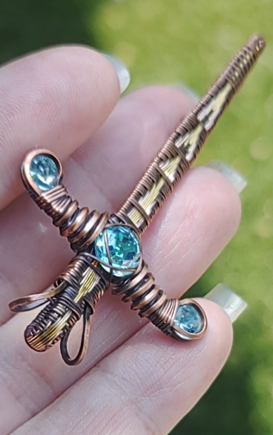 Gold Sword ⚔️ with three blue crystals